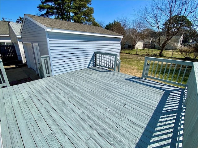 wooden deck with a lawn and an outdoor structure