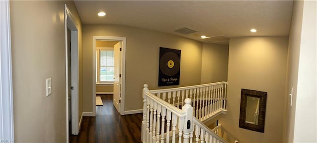 hallway with an upstairs landing, visible vents, recessed lighting, and wood finished floors