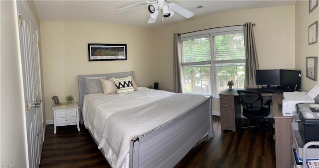 bedroom featuring visible vents, baseboards, dark wood finished floors, and a ceiling fan