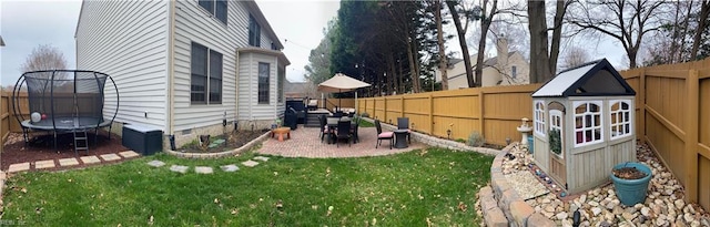 view of yard featuring a trampoline and a fenced backyard