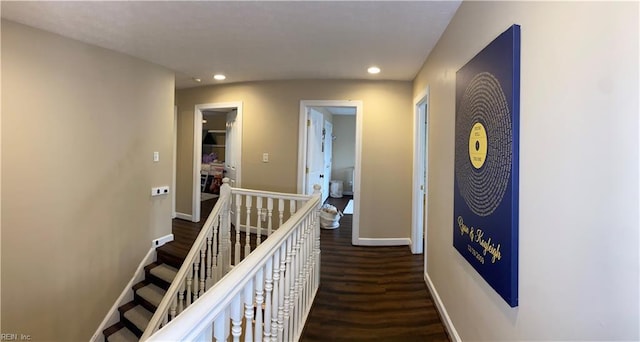 corridor featuring an upstairs landing, recessed lighting, baseboards, and wood finished floors