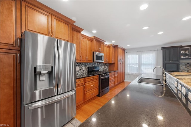 kitchen with recessed lighting, backsplash, stainless steel appliances, and a sink