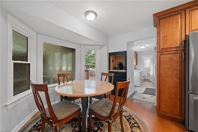 dining space featuring wood finished floors and baseboards