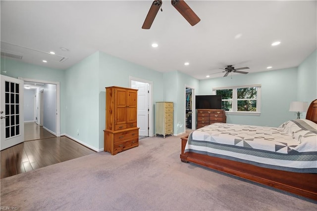 bedroom featuring recessed lighting, attic access, a walk in closet, and baseboards