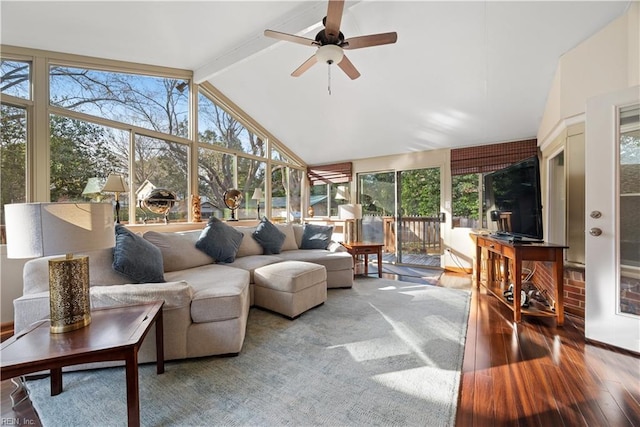 sunroom featuring lofted ceiling with beams and a ceiling fan