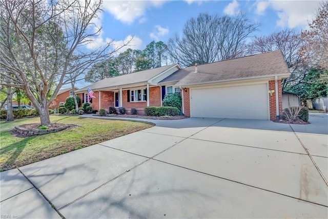 ranch-style house with a front yard, brick siding, an attached garage, and driveway