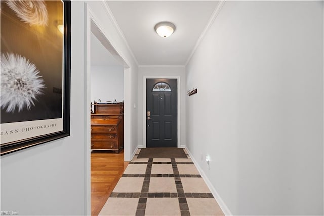 entryway featuring wood finished floors, baseboards, and ornamental molding