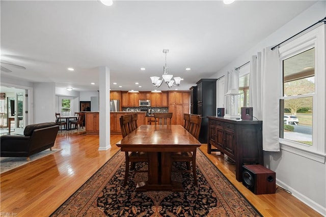 dining room featuring light wood finished floors, a chandelier, recessed lighting, and baseboards