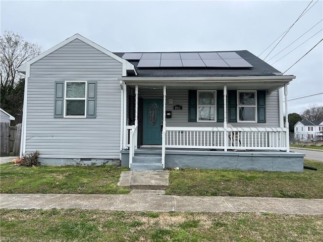 bungalow with crawl space, covered porch, and solar panels