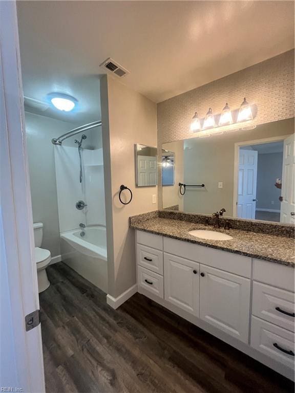 full bathroom featuring visible vents, baseboards, toilet, wood finished floors, and vanity