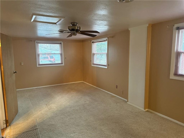 empty room with baseboards, carpet floors, and a textured ceiling