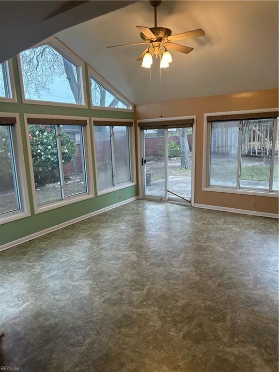 unfurnished sunroom with a ceiling fan and vaulted ceiling