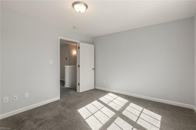 unfurnished bedroom featuring carpet flooring and baseboards