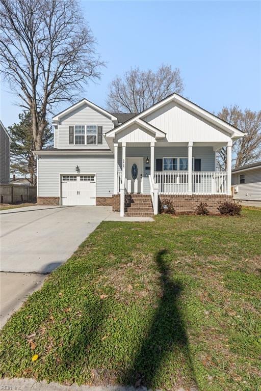 view of front of house featuring a garage, concrete driveway, a porch, and a front lawn