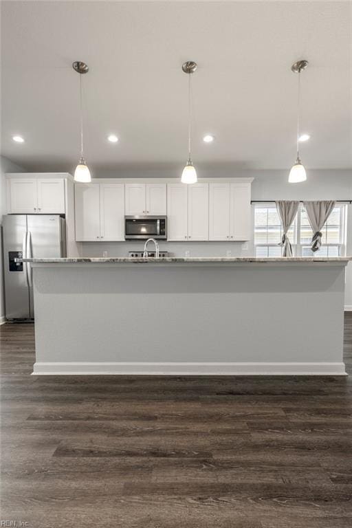 kitchen with dark wood finished floors, recessed lighting, appliances with stainless steel finishes, white cabinetry, and decorative light fixtures