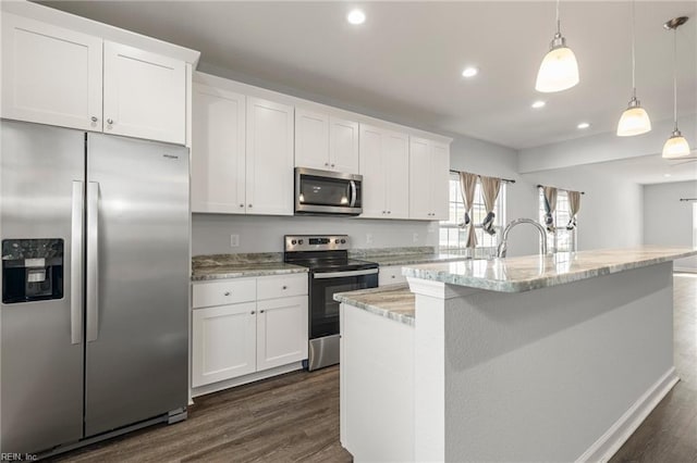 kitchen with dark wood-style floors, a center island with sink, white cabinets, and stainless steel appliances