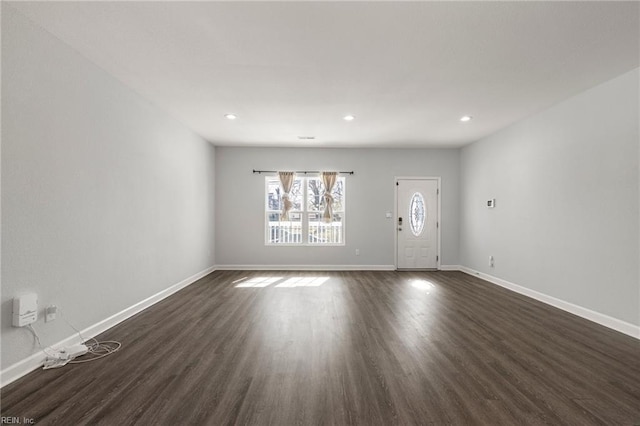 unfurnished living room with recessed lighting, baseboards, and dark wood-style flooring