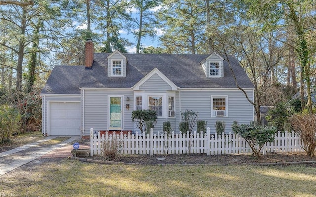 cape cod house with a fenced front yard, an attached garage, a chimney, and driveway