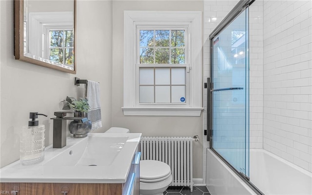 full bath with tile patterned flooring, plenty of natural light, toilet, and radiator heating unit