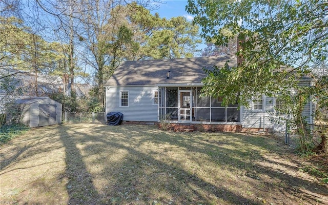 back of property featuring a storage unit, an outbuilding, fence, a sunroom, and crawl space