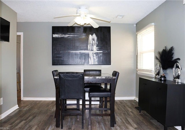 dining area featuring a ceiling fan, baseboards, and wood finished floors