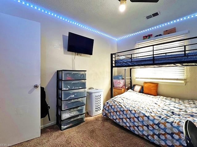 carpeted bedroom featuring visible vents and a textured ceiling