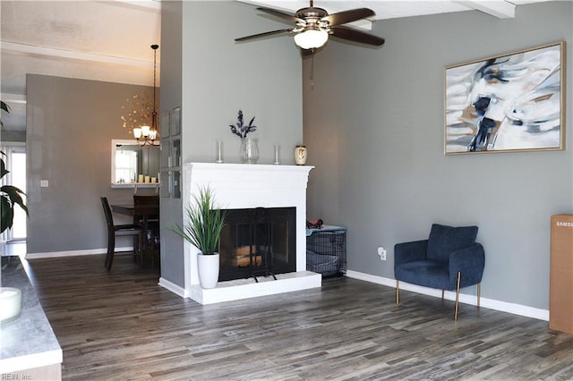 living room featuring beamed ceiling, wood finished floors, baseboards, and a fireplace with raised hearth