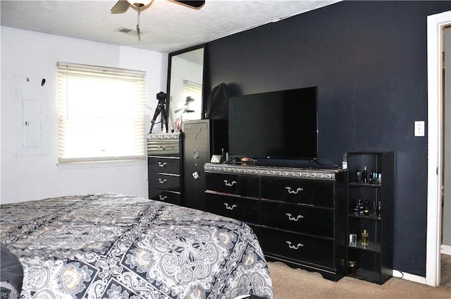 carpeted bedroom featuring electric panel and a ceiling fan