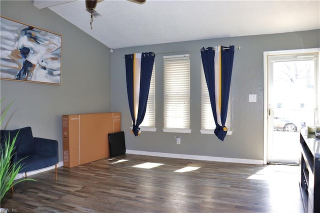 entrance foyer with vaulted ceiling, wood finished floors, and baseboards