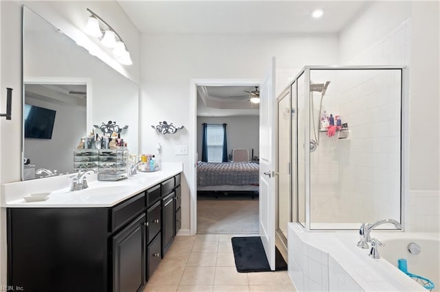 ensuite bathroom featuring vanity, ensuite bath, a stall shower, ceiling fan, and tile patterned floors