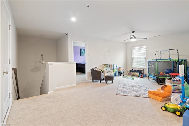 recreation room with carpet flooring and a ceiling fan