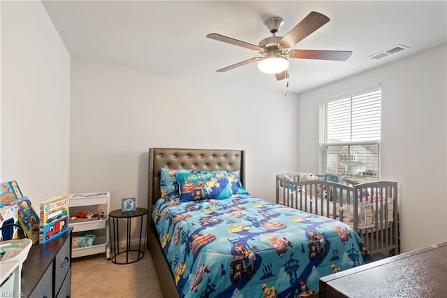 carpeted bedroom featuring visible vents and ceiling fan