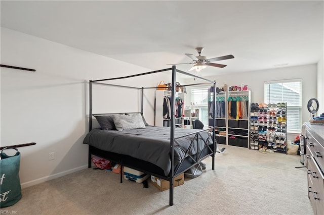 bedroom with multiple windows, baseboards, and carpet