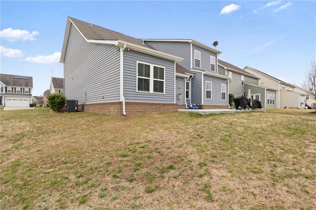 back of property with central air condition unit, a patio, and a lawn