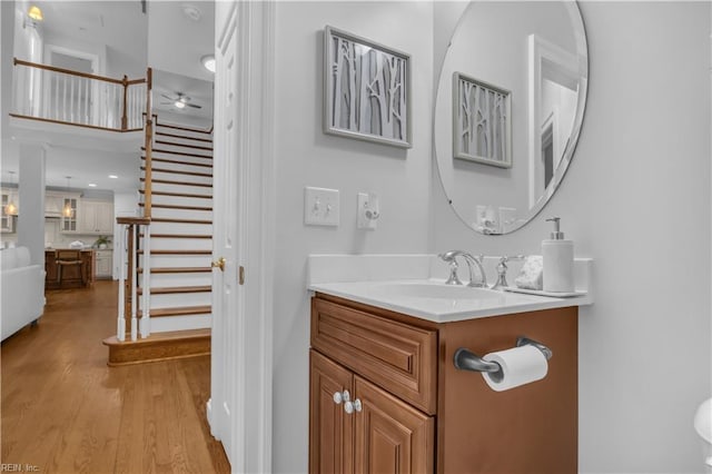 bathroom with vanity, a ceiling fan, and wood finished floors