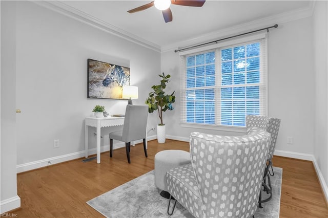 home office with wood finished floors, a ceiling fan, baseboards, and ornamental molding