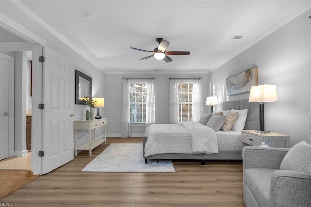 bedroom featuring baseboards, light wood-type flooring, a ceiling fan, and ornamental molding