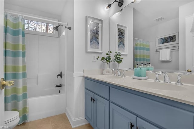 full bathroom with tile patterned floors, visible vents, toilet, a sink, and double vanity