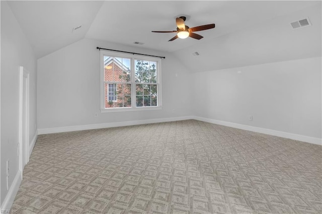 additional living space with visible vents, ceiling fan, lofted ceiling, and baseboards