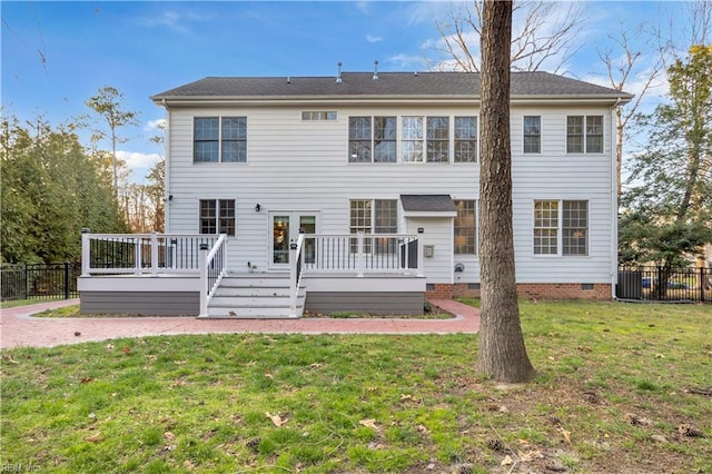 back of property with a wooden deck, a yard, fence, and crawl space