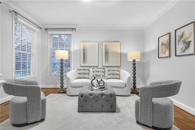 living area with ornamental molding, baseboards, and wood finished floors