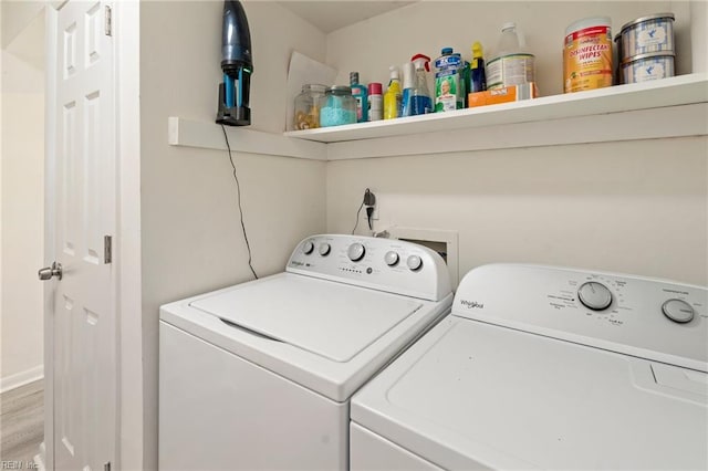 clothes washing area featuring washing machine and dryer and laundry area