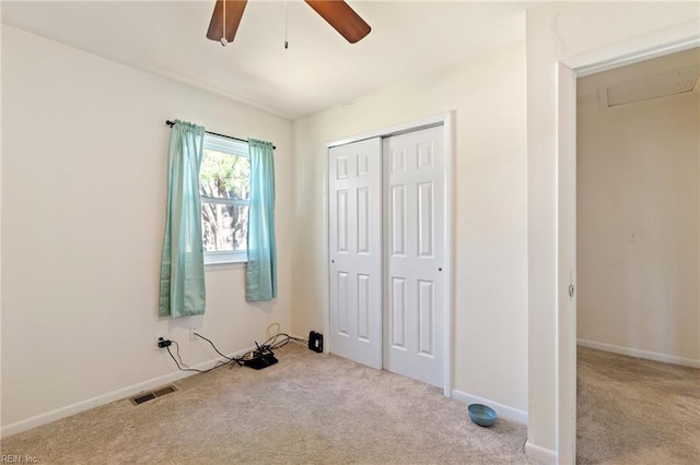 unfurnished bedroom featuring a closet, visible vents, carpet flooring, and baseboards