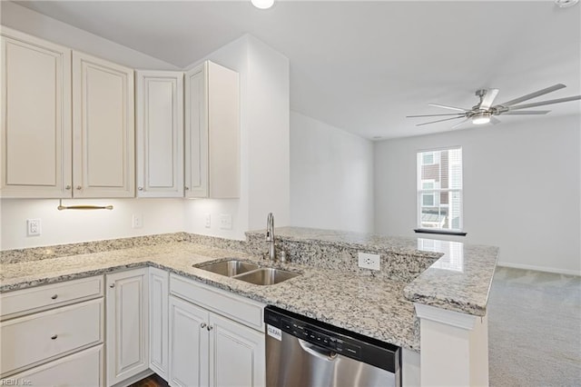 kitchen with a ceiling fan, a peninsula, a sink, light carpet, and stainless steel dishwasher