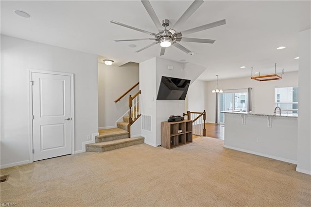 living room featuring light carpet, visible vents, recessed lighting, and baseboards