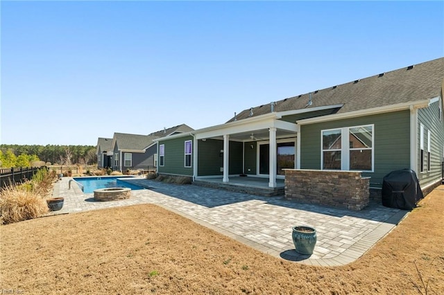 view of pool with a fire pit, a patio, fence, and grilling area