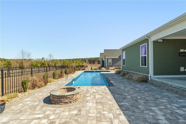 view of swimming pool with a patio area, a fire pit, a fenced in pool, and fence