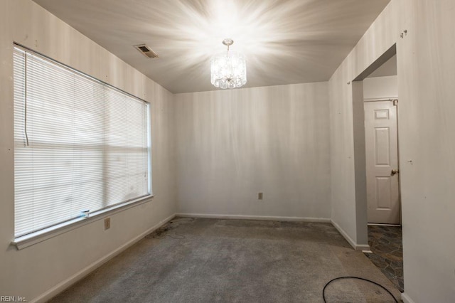 empty room featuring baseboards, visible vents, carpet floors, and a chandelier