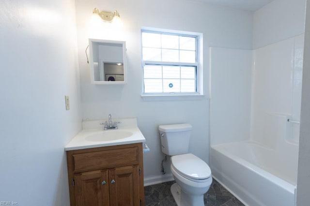 bathroom featuring baseboards, toilet, and vanity