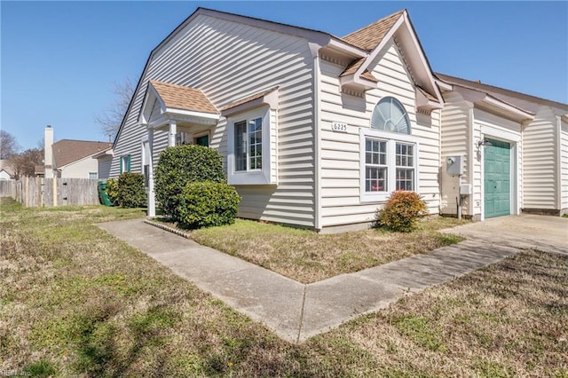 view of side of property with a garage and fence